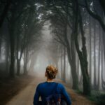 woman walking in misty forest